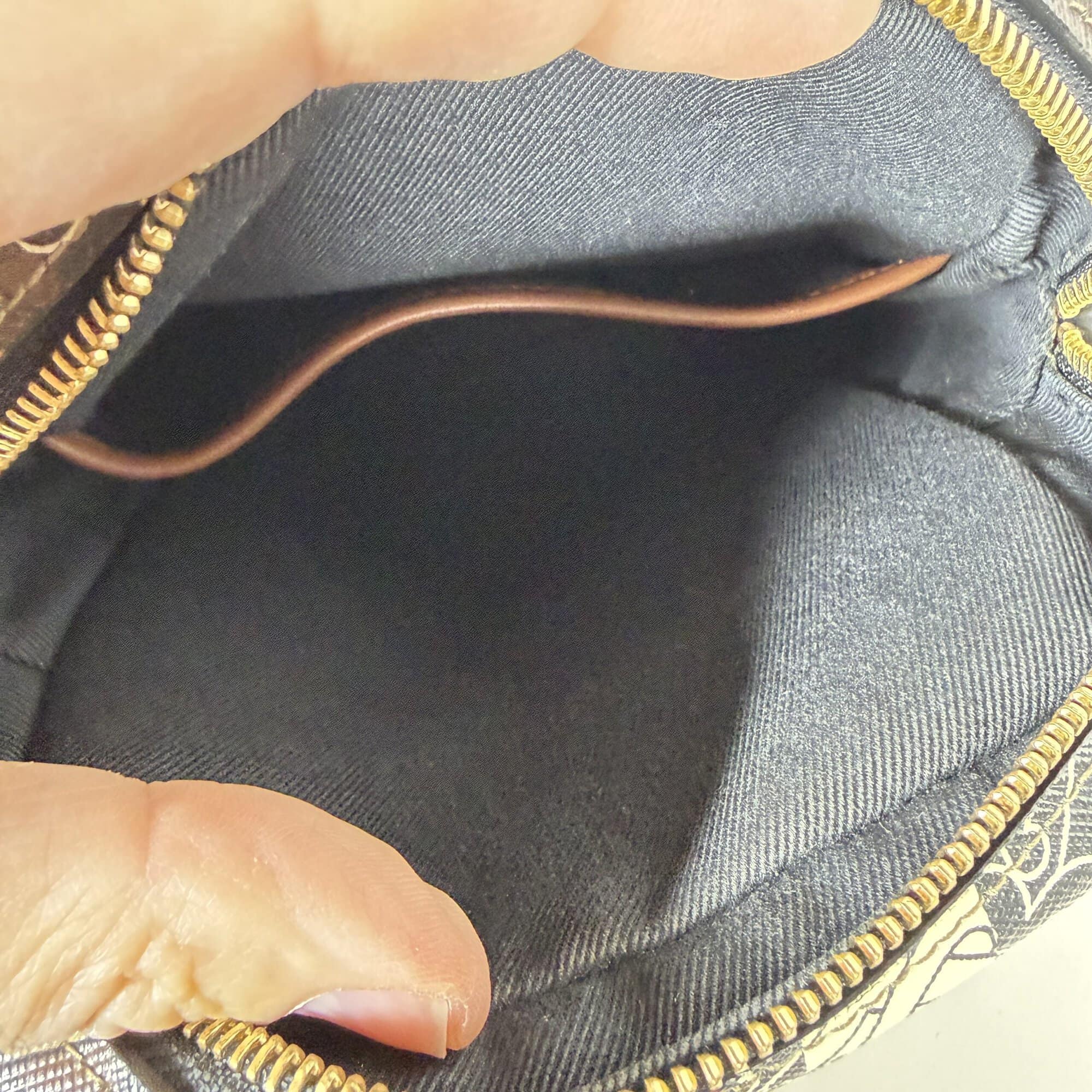 Main interior compartment of Burberry crossbody bag showing textile lining and pocket