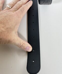 Adjustment holes on smooth black interior side of belt strap