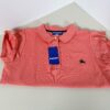 Folded coral Burberry Blue Label polo shirt showing collar, chest logo, and attached tag