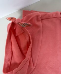 Detail of sleeve cuff with knotted tie showing Nova check trim lining