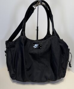 Front view of black nylon Kate Spade tote bag with patent handles and logo plaque